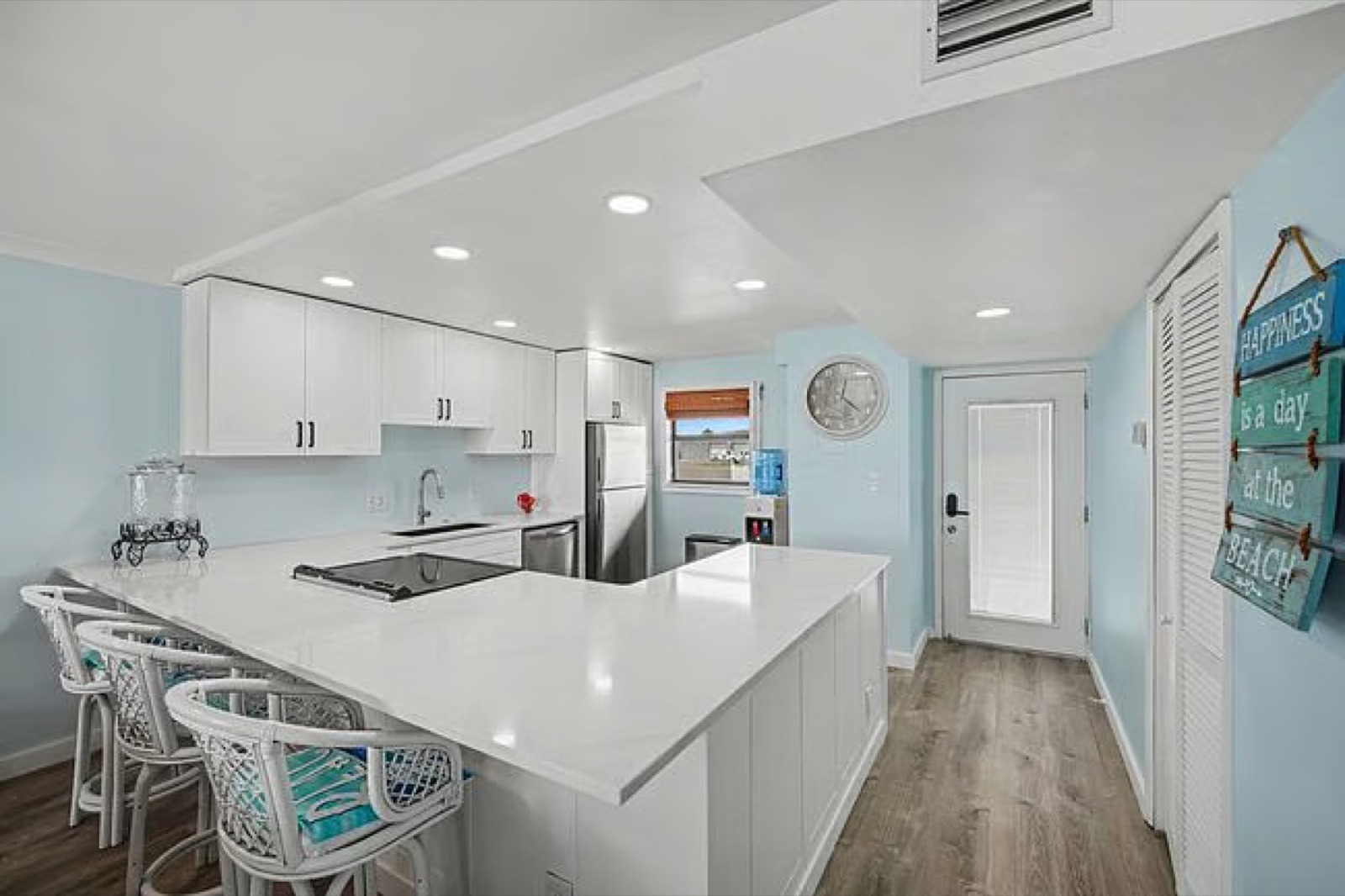 Renovated kitchen with custom shaker cabinetry and quartz counters